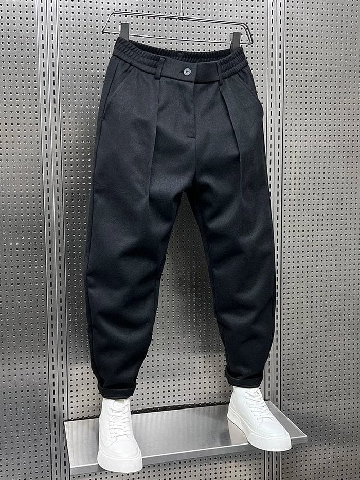 Men's Pleated Tapered Trousers with Belt Loops in Black – angled front view | Hensley London