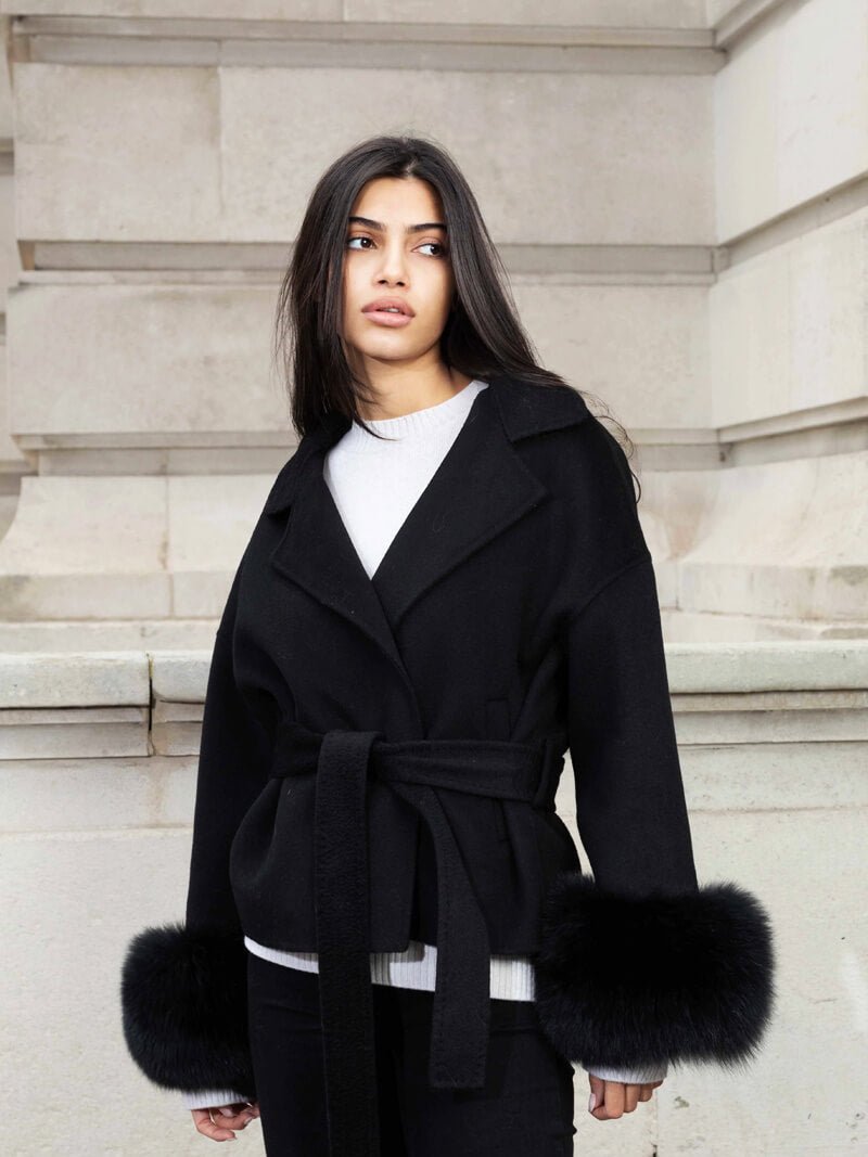 Women's Belted Shawl-Collar Coat with Textured Cuffs in Black – front worn view | Hensley London