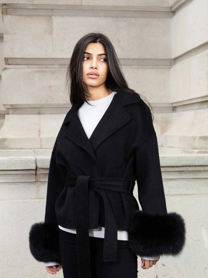 Women's Belted Shawl-Collar Coat with Textured Cuffs in Black – front worn view | Hensley London