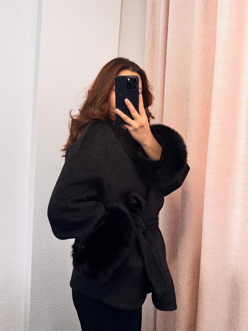 Women's Belted Shawl-Collar Coat with Textured Cuffs in Black – front worn view | Hensley London